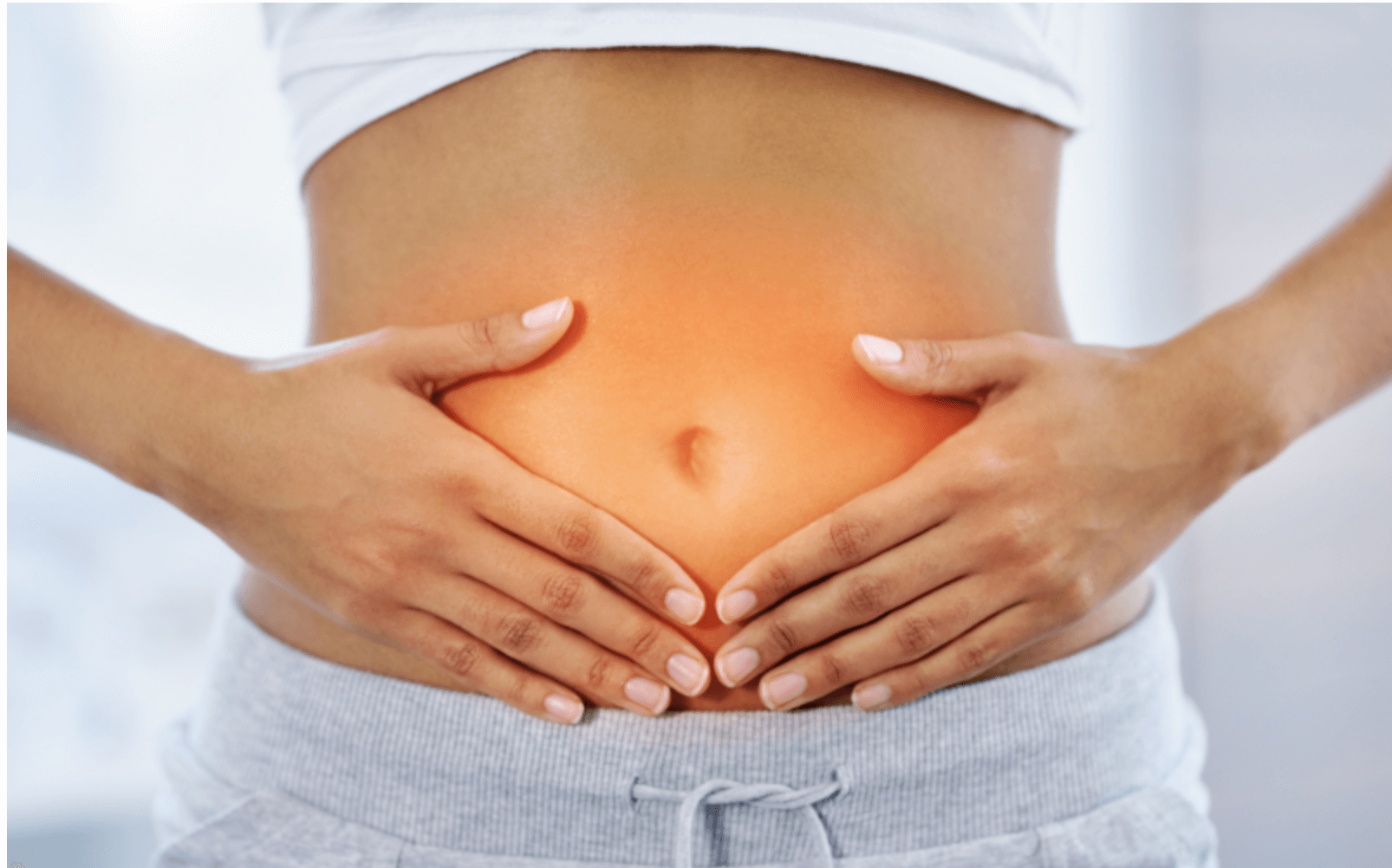 woman holding her abdomen, promoting the benefits of massage for relaxation and health